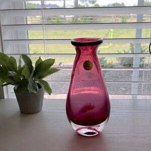 Gorgeous Rossi Glass bud vase, hand blown in Canada. The color is cranberry.